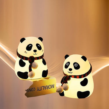 Two panda-shaped night lights with a warm glow on a beige background.